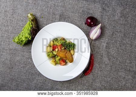 Salad With Black Sea Rapan Meat, Dressed With Honey Sauce. With Rye Crackers. On A Gray Canvas Cloth
