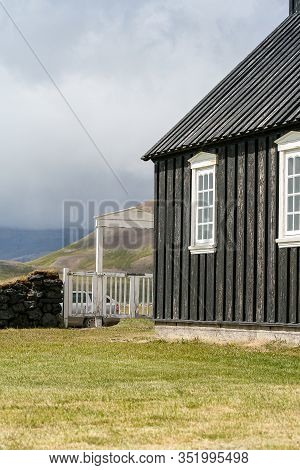 The Black Tarred Búðakirkja Timber Church On The Seashore In Iceland