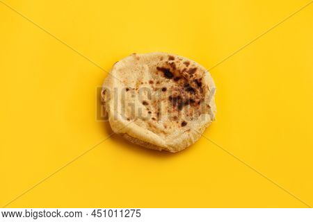 Egyptian Bread Aish Baladi. Fresh Bread Lies On The Yellow Table