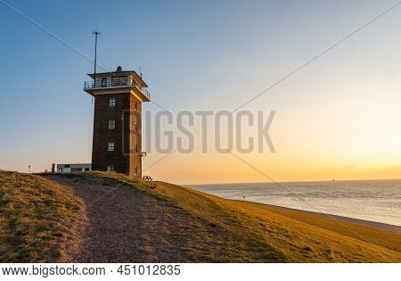 Historical Coast Guard Tower In Dutch Village Huisduinen By Sunset