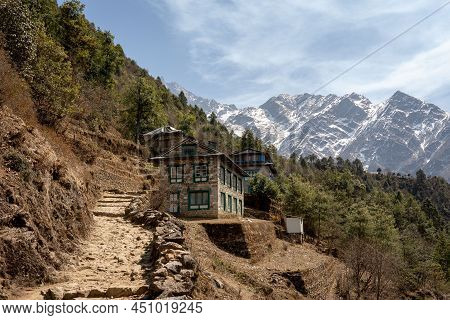 Some Houses Built Beside A Dirt Mountain Trail In The Himalaya Mountains Of Nepal In The Everest Reg
