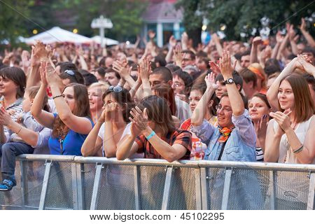 MOSCOW - JUN 23: Music fans applaud at concert of Chaif rock-band during VII traditional festival of live sound Music of Summer in Hermitage Garden, Jun 23, 2012, Moscow, Russia.