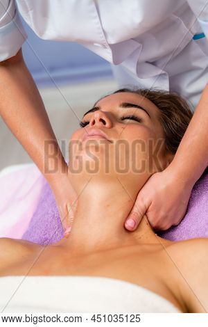 Facial Massage. A Woman Is Given A Massage In A Beauty Salon. Close-up.