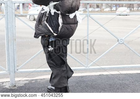 Tramp Beggar On City Street In A Torn Fur Coat Jacket