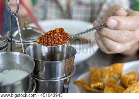 Hand Of Senior Woman Holding Spoon Full Of Cayenne Pepper,old Elderly Eat Spicy Food Or Eat Too Much