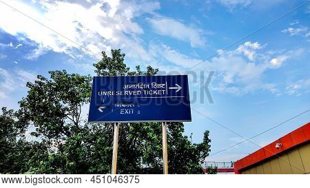 The Unreserved Ticket Sign Board At New Delhi Railway Station With Cloudy Sky