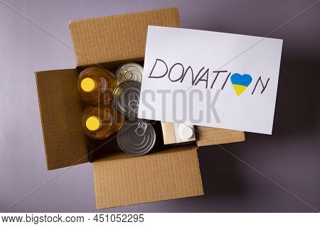 Donation For People From Ukraine. Food Donations Boxes With Grocery Products And White Card With Tex
