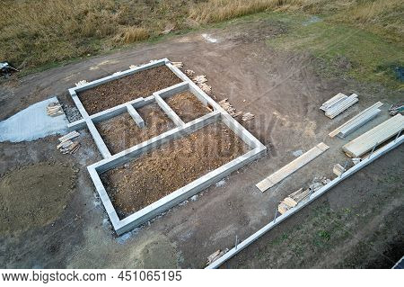 Top Down Aerial View Of Building Works Of New House Concrete Foundation On Construction Site.