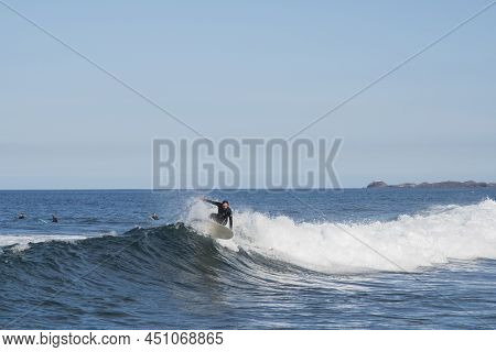 Corralejo Fuerteventura Spain, 01-20-2022 Winter Surfer Riding A Wave With Lanzarote In The Backgrou