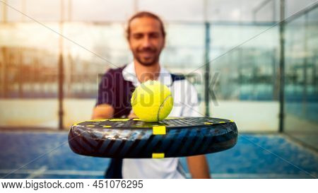 Monitor Of Padel Holding Black Racket With Yellow Tennis Ball Over. Class To Student On Outdoor Tenn