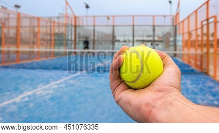 Monitor Holding Paddle Tennis Ball For Teaching Padel. Class On Outdoor Court.
