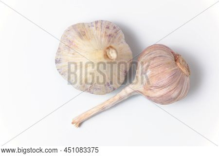 Two Fresh Garlic Lie On A White Background. Close Up Top View.