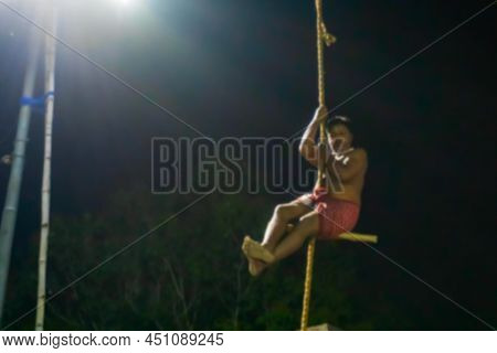 Blurred Image Of Howrah, West Bengal,india. Hindu Devotee Hanging From Pole In Air, At Night. Religi