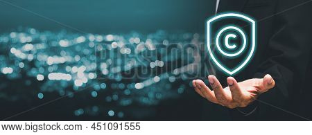 Copyright Or Patent Concept, Business Person Hand Holding Vr Screen Copyright Icon With Blue Bokeh B