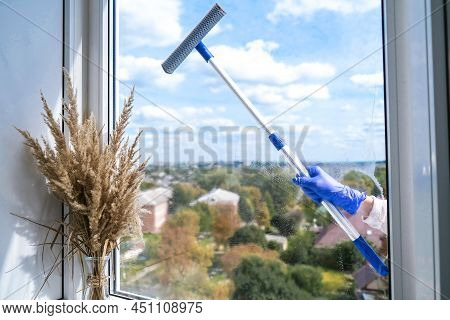 Employee Hand In Rubber Protective Glove Cleans Window With Foam And Puller. General Spring Cleaning