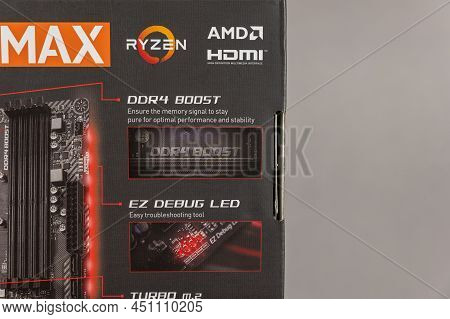 Msi B450 Mortal Max Motherboard Against A Gray Background. Black Box With The New Computer Hardware.