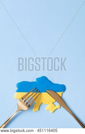 Yellow And Blue Ukrainian Map With Fork And Knife, Top View.aggression Against Ukraine Concept. Copy