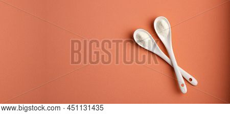 Hydrolyzed Collagen Powder In Two Ceramic Spoons