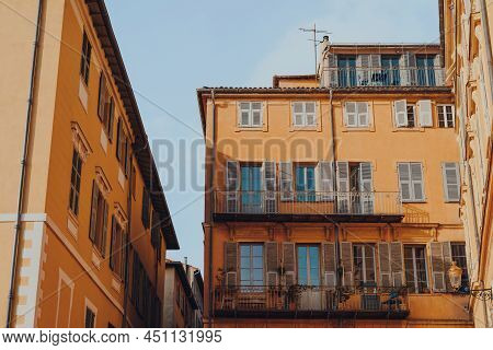 Low Angle View Of Traditional Colourful Buildings With Wooden Shutters On Windows In The Old Town Of