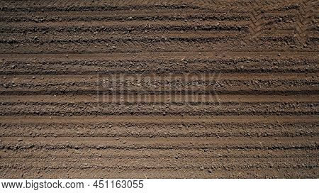 Farming: A Farmer On A Tractor Works The Field Before Sowing