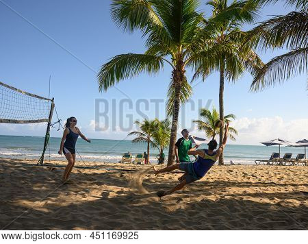 Playing Volleyball On Beach. People Who Playing On The Beach Of Atlantic Ocean. Team Game Om Summer 