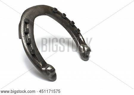 Close Up Of Already Shod Used Authentic Steel Metal Horseshoe With Nail Heads Visible On White Backg