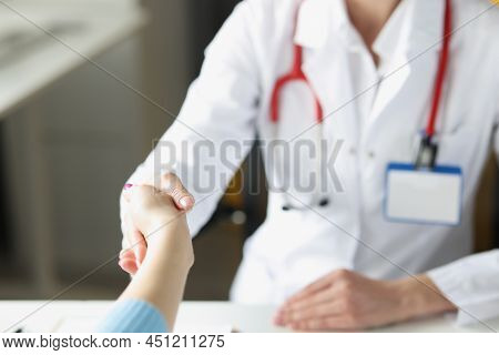 Close-up Of Doctor Woman Greet Patient And Shake Hand, Medical Worker In Uniform. Intern Ready For A