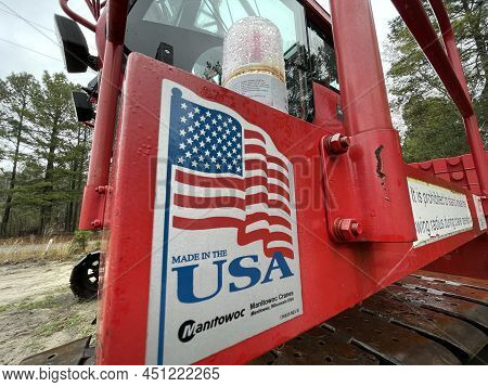 Augusta, Ga Usa - 03 19 22: Manitowoc Red Crane Construction Scene Cloudy Rainy Day Made In Usa Sign