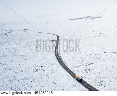 Aerial View Of A82 Road Through Rannoch Moor And Black Mount Covered In Snow During Winter