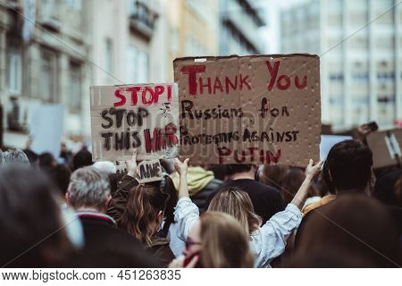 Lisbon, Portugal - February 27, 2022: Selective Focus On One Of Two Cardboard Posters With The Capti