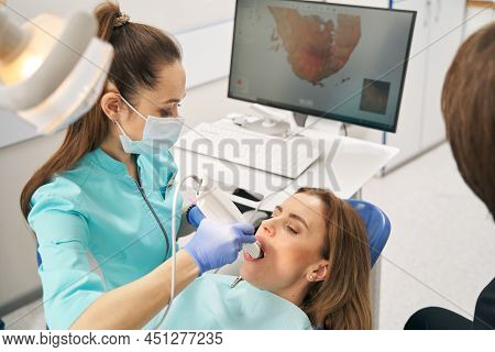 Dentist Scanning Woman Teeth With Dental Intraoral 3d Scanner