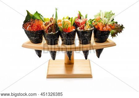 Temaki Set Set of  Salmon tuna temaki, shrimp tobiko temaki , salmon caviar (Ikura) on wooden plank isolated on white background