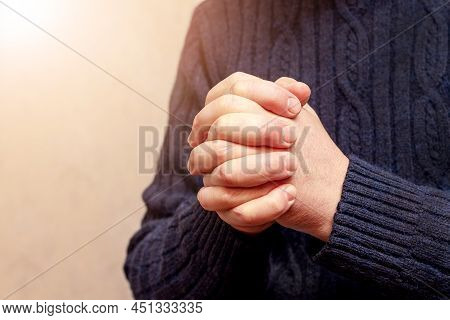 Man During Prayer. Prayer For Peace In Ukraine. Man's Hands During Prayer