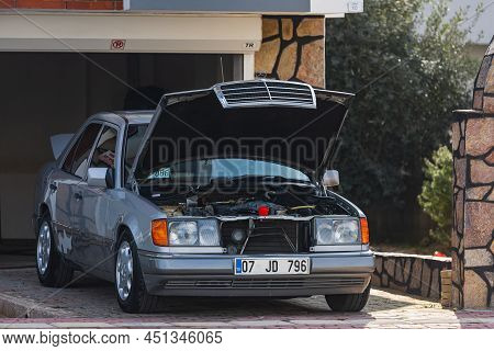 Side; Turkey - March 03 2022:    Gray Mercedes-benz E-class With Open Hood  Is Parked  On The Street