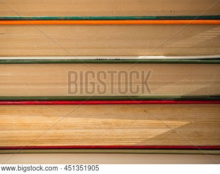 A Stack Of Hardcover Books. Old, Battered And Faded Hardcover Books Or Textbooks In A Bookstore Or L
