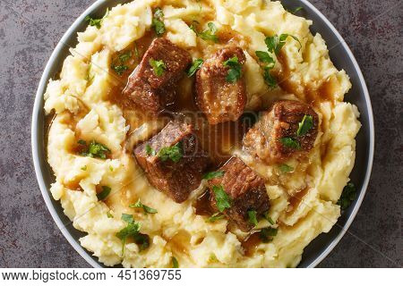 Greek Sofrito Slow Braised Beef With Spicy Gravy Garnished With Mashed Potatoes Close-up In A Plate 