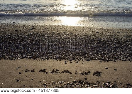 The Inscription In English Ukraine On The Sand Of The Beach On The Shore Of The Tyrrhenian Sea Again