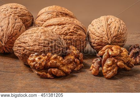 Ripe Walnuts On A Wooden Table.  Walnut Fresh Nuts Background Top View
