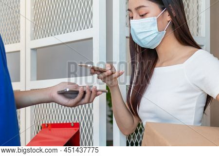 Asian Young Woman, Client Wearing Face Mask, Use Mobile Scan Received  Delivery Of Cardboard Box Fro