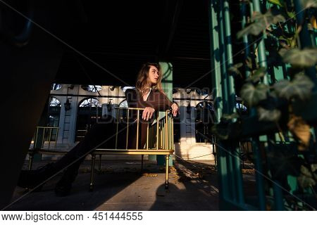 Portrait Of A Fashionable Young Brunette Woman With Long Legs Wearing Solid Long Sleeve Bodycon One 