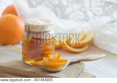 Homemade Candied Peels Orange Confiture In Glass Jar On Light Background, Selective Focus