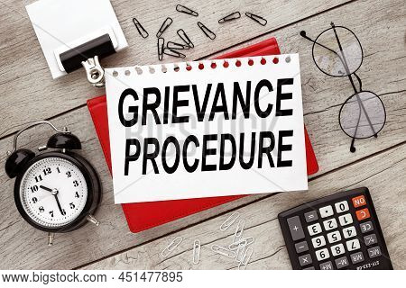 Grievance Procedure Text On A Piece Of Paper With Text On A Red Notepad