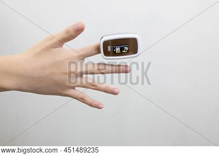 Hand Of Asian Child Girl With An Attached Pulse Oximeter On Fingertip,lady Measuring Heart Rate,chec