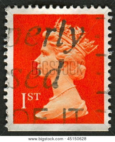UK-CIRCA 1990:A stamp printed in UK shows image of Elizabeth II is the constitutional monarch of 16 sovereign states known as the Commonwealth realms, in red, circa 1990.