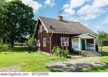Ulva, Uppland - Sweden - 07 29 2019 Typical Red Wooden Swedish Summer Countryhouse And Garden