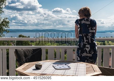 Segersta, Halsingland - Sweden - 08 04 2019   Attractive Woman In Summer Dress Posing At A Terrace O