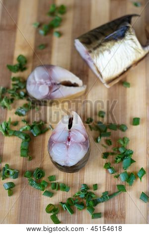 Großes Stück Bloater und Frühlingszwiebeln auf dem Brett