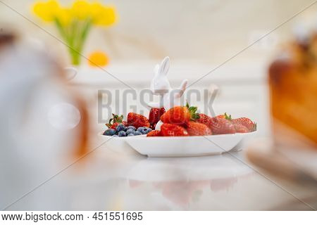 Strawberries And Blueberries In A White Compartmental Dish With Rabbit.