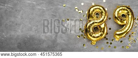 Yellow Foil Balloon Number, Number Eighty Nine On A Concrete Background. Greeting Card With The Insc