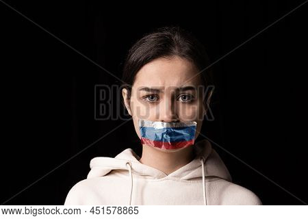 Half-legth Portrait Of Young Emotional Upset Girl With Three Colors Duct Tape Over Her Mouth Isolate